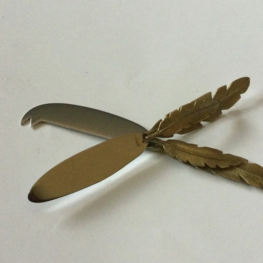 MICHAEL ARAM SET OF 2 FEATHER HANDLED CHEESE KNIVES NWT